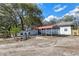 Exterior of home showing multiple covered parking areas and brick facade at 1343 Spring Lake Rd, Fruitland Park, FL 34731