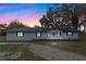Charming single-story home featuring a brick exterior, dark shutters, and a well-maintained front yard at 1343 Spring Lake Rd, Fruitland Park, FL 34731
