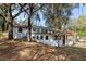 Exterior of house showing brick facade, covered parking, lush yard and newer roof at 1343 Spring Lake Rd, Fruitland Park, FL 34731