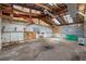 Spacious, unfinished garage with concrete floors and exposed ceiling beams at 1343 Spring Lake Rd, Fruitland Park, FL 34731