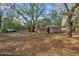 Backyard with separate outbuilding on a large private lot with mature trees at 1343 Spring Lake Rd, Fruitland Park, FL 34731