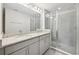Modern bathroom with double sink vanity, granite countertop, and glass-enclosed shower at 1412 Captiva Cv, Sanford, FL 32771