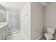 Clean bathroom featuring a glass-enclosed shower, modern fixtures, and a toilet at 1412 Captiva Cv, Sanford, FL 32771
