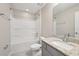 Bright bathroom featuring a granite vanity, framed mirror, and a shower-tub combo at 1412 Captiva Cv, Sanford, FL 32771