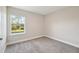 Bright, carpeted room featuring a window with a view of the outdoors at 1412 Captiva Cv, Sanford, FL 32771