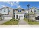 Charming townhome featuring a paved walkway and a one-car garage for convenient parking and curb appeal at 1412 Captiva Cv, Sanford, FL 32771