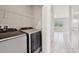 Well-equipped laundry room featuring modern washer and dryer units and ample shelving space at 1412 Captiva Cv, Sanford, FL 32771
