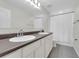 A full bathroom featuring a double sink vanity, a large mirror and tile flooring at 157 Primrose Dr, Davenport, FL 33837