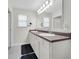 Bright bathroom featuring a double sink vanity, a large mirror and neutral tile flooring at 157 Primrose Dr, Davenport, FL 33837