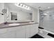 Bright bathroom with double sinks, a large mirror, and a walk-in shower with glass doors at 157 Primrose Dr, Davenport, FL 33837