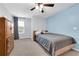 Bedroom with blue accent wall, carpeted floor, ceiling fan, and a window offering natural light at 157 Primrose Dr, Davenport, FL 33837