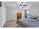 Cozy bedroom with carpeted floor, ceiling fan, window, and closet for ample storage at 157 Primrose Dr, Davenport, FL 33837