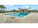 A view of the large community pool with tables, chairs, and restroom building at 157 Primrose Dr, Davenport, FL 33837