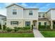 Charming two-story home with a well-manicured lawn and landscaped garden and welcoming front entrance at 157 Primrose Dr, Davenport, FL 33837