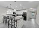 Bright kitchen featuring white cabinets, an island with bar seating, and stainless steel appliances at 157 Primrose Dr, Davenport, FL 33837