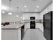 Spacious kitchen with white cabinets and a breakfast bar, complete with modern appliances and lighting at 157 Primrose Dr, Davenport, FL 33837