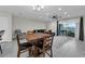 Spacious living area with tile flooring, dining space, and access to outdoor patio through sliding doors at 157 Primrose Dr, Davenport, FL 33837