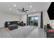 Open-concept living room with tile floors, dark furnishings, and access to outdoor patio space at 157 Primrose Dr, Davenport, FL 33837