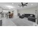 Open-concept living space with a view of the kitchen, dining area, and comfortable seating arrangement at 157 Primrose Dr, Davenport, FL 33837