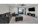 Bright living room with comfortable seating, ceiling fan, and sliding door leading to outdoor space at 157 Primrose Dr, Davenport, FL 33837