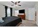 Comfortable main bedroom with a ceiling fan, large windows, and ample closet space at 157 Primrose Dr, Davenport, FL 33837