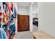 A spacious walk-in closet with wooden drawers for storage and a view into the main bedroom at 157 Primrose Dr, Davenport, FL 33837