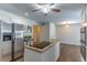 Kitchen featuring stainless steel refrigerator, island cooktop, and hardwood flooring at 1821 Myrtle Lake Hills Rd, Longwood, FL 32750