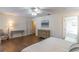 Spacious main bedroom with hardwood floors, furniture, ceiling fan and ensuite bathroom access at 1821 Myrtle Lake Hills Rd, Longwood, FL 32750