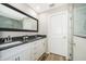 Bright bathroom features dual sinks, granite counters, framed mirror and updated flooring at 1965 3Rd Dr, Sanford, FL 32771