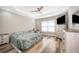 Serene bedroom with tray ceilings, hardwood floors, and a window with blinds at 1965 3Rd Dr, Sanford, FL 32771