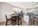 Dining area with a wooden table, chairs, and a view of the kitchen and living space at 1965 3Rd Dr, Sanford, FL 32771
