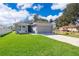 Charming one-story home with a grey exterior, well-manicured lawn, and a two-car garage at 1965 3Rd Dr, Sanford, FL 32771