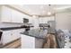 Kitchen island with white cabinets, granite countertops, and stainless steel appliances at 1965 3Rd Dr, Sanford, FL 32771
