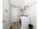 Functional laundry room with washer, dryer, utility sink and overhead shelving at 1965 3Rd Dr, Sanford, FL 32771