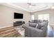 Comfortable living room with a large sectional sofa, ceiling fan, and a flat-screen TV at 1965 3Rd Dr, Sanford, FL 32771