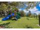 Playground featuring slides, climbing structure, and swing set on artificial turf at 1965 3Rd Dr, Sanford, FL 32771