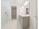 Modern bathroom with double vanity, gray cabinets, white subway tile shower, and access to a walk in closet at 2120 Antilles Club Dr # 10, Kissimmee, FL 34747
