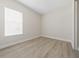 Bedroom with vinyl plank flooring, a large window with white blinds, and a neutral color palette at 2120 Antilles Club Dr # 10, Kissimmee, FL 34747