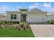 Charming single-story home featuring a two-car garage, well-manicured lawn, and a brick driveway at 2120 Antilles Club Dr # 10, Kissimmee, FL 34747