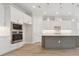 Modern kitchen featuring white cabinets, stainless steel appliances, and an island with pendant lighting at 2120 Antilles Club Dr # 10, Kissimmee, FL 34747