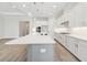 Bright kitchen with an island, white cabinets, stainless steel appliances, and wood-look flooring at 2120 Antilles Club Dr # 10, Kissimmee, FL 34747