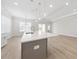 Living space with a kitchen island, white cabinets, and wood-look flooring at 2120 Antilles Club Dr # 10, Kissimmee, FL 34747