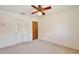 Carpeted bedroom featuring a ceiling fan and a closet at 2450 Nela Ave, Belle Isle, FL 32809