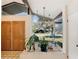 Bright and welcoming foyer featuring a double door, plant area, and tiled flooring at 2450 Nela Ave, Belle Isle, FL 32809