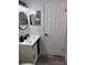 Bright bathroom features a modern vanity with round mirror and updated fixtures at 2652 Graduate Ct, Orlando, FL 32826