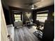 Cozy bedroom with two large windows, hardwood floors, ceiling fan and a desk area at 2652 Graduate Ct, Orlando, FL 32826