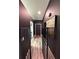 Hallway with luxury vinyl flooring, wainscoting and pet gate, providing safety and style at 2652 Graduate Ct, Orlando, FL 32826