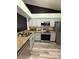 Modern kitchen featuring granite countertops, stainless steel appliances, and luxury vinyl flooring at 2652 Graduate Ct, Orlando, FL 32826