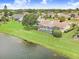 Aerial view of backyard with screened pool overlooking lake in a beautiful residential neighborhood at 2732 Lone Feather Dr, Orlando, FL 32837
