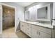 The bathroom features a double sink vanity, decorative mirrors, and a glass shower at 2732 Lone Feather Dr, Orlando, FL 32837